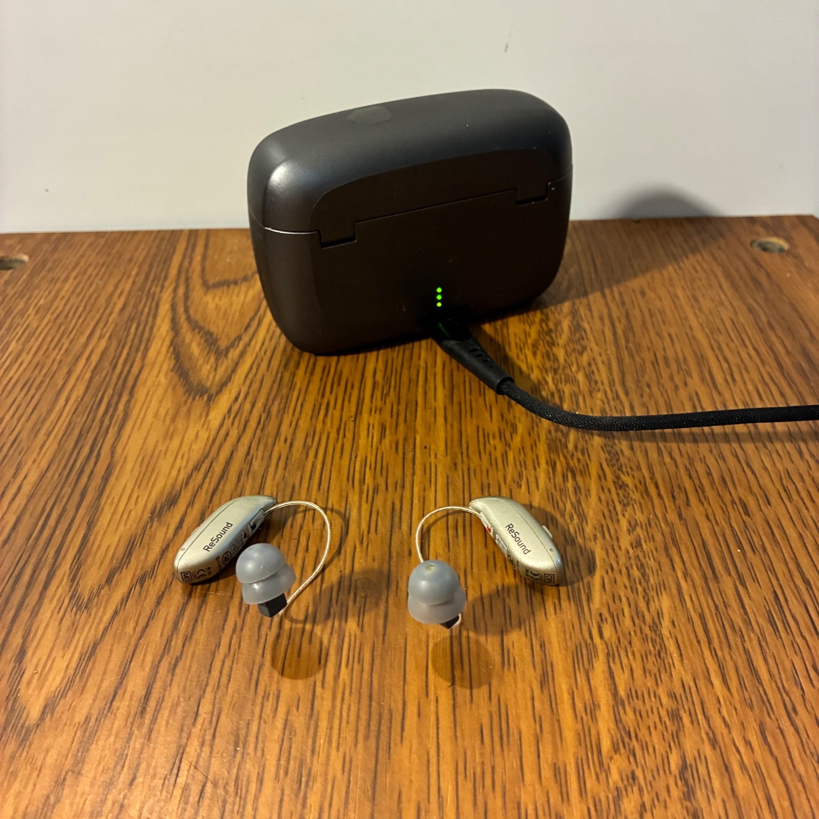 Left and Right Resound GN Hearing Aids and charging station w/cord.
