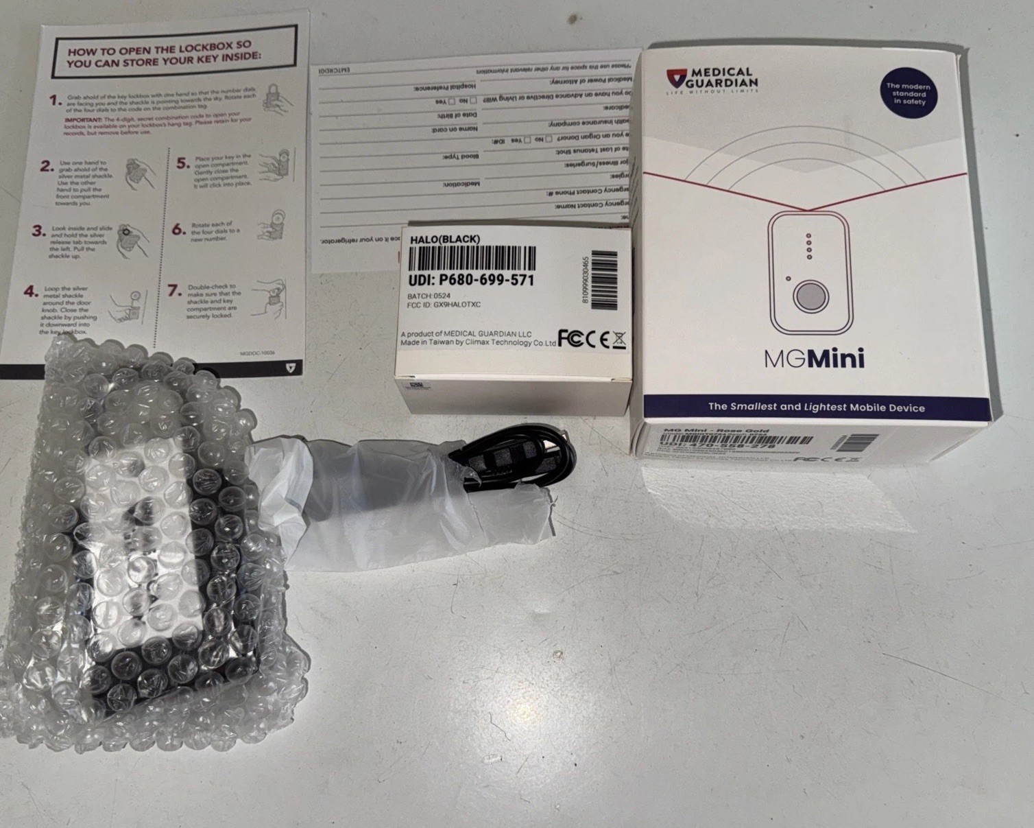 Medical Guardian MG Mini Medical Alert Device with Accessories lockbox open box