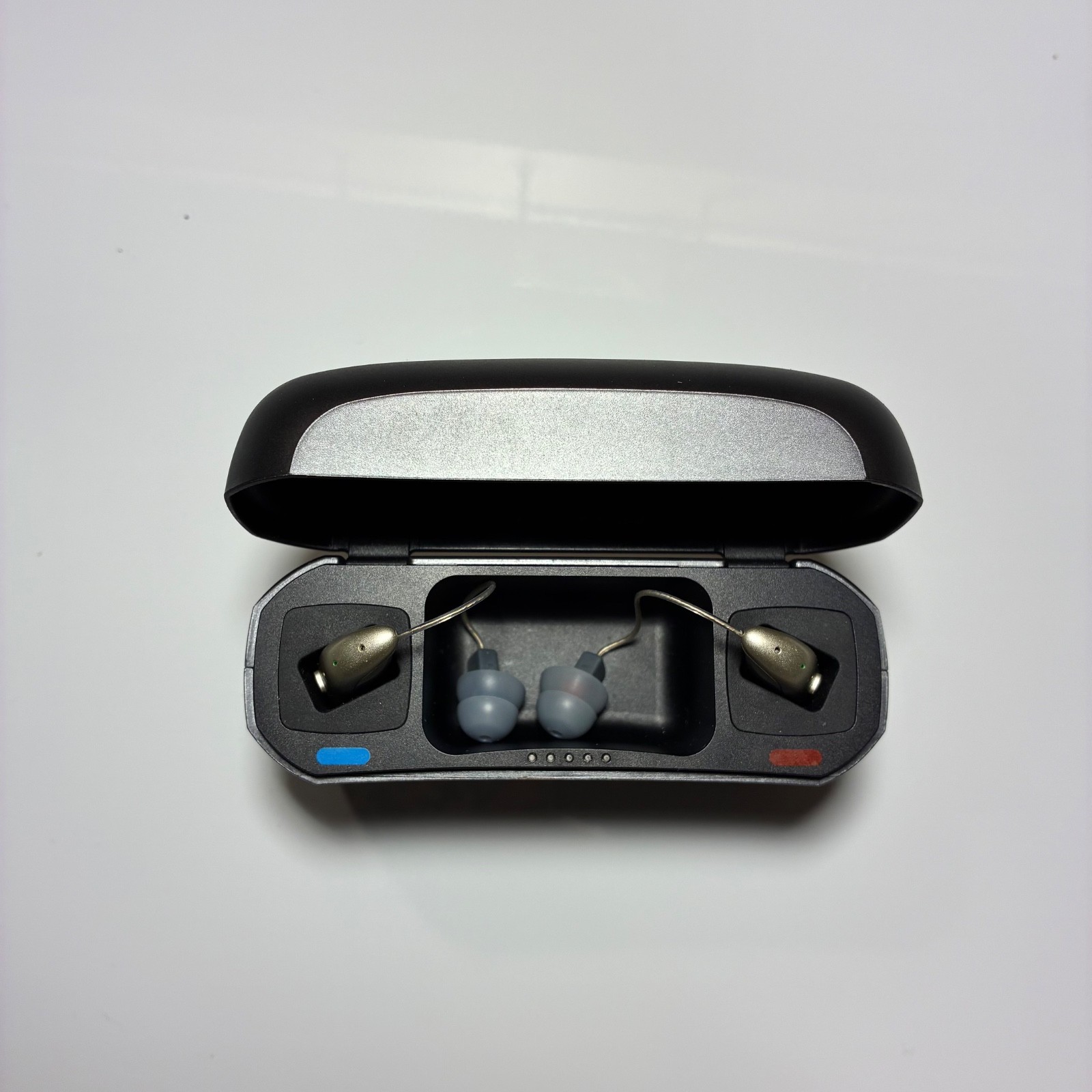 Left and Right Resound GN Hearing Aids and charging station w/cord.