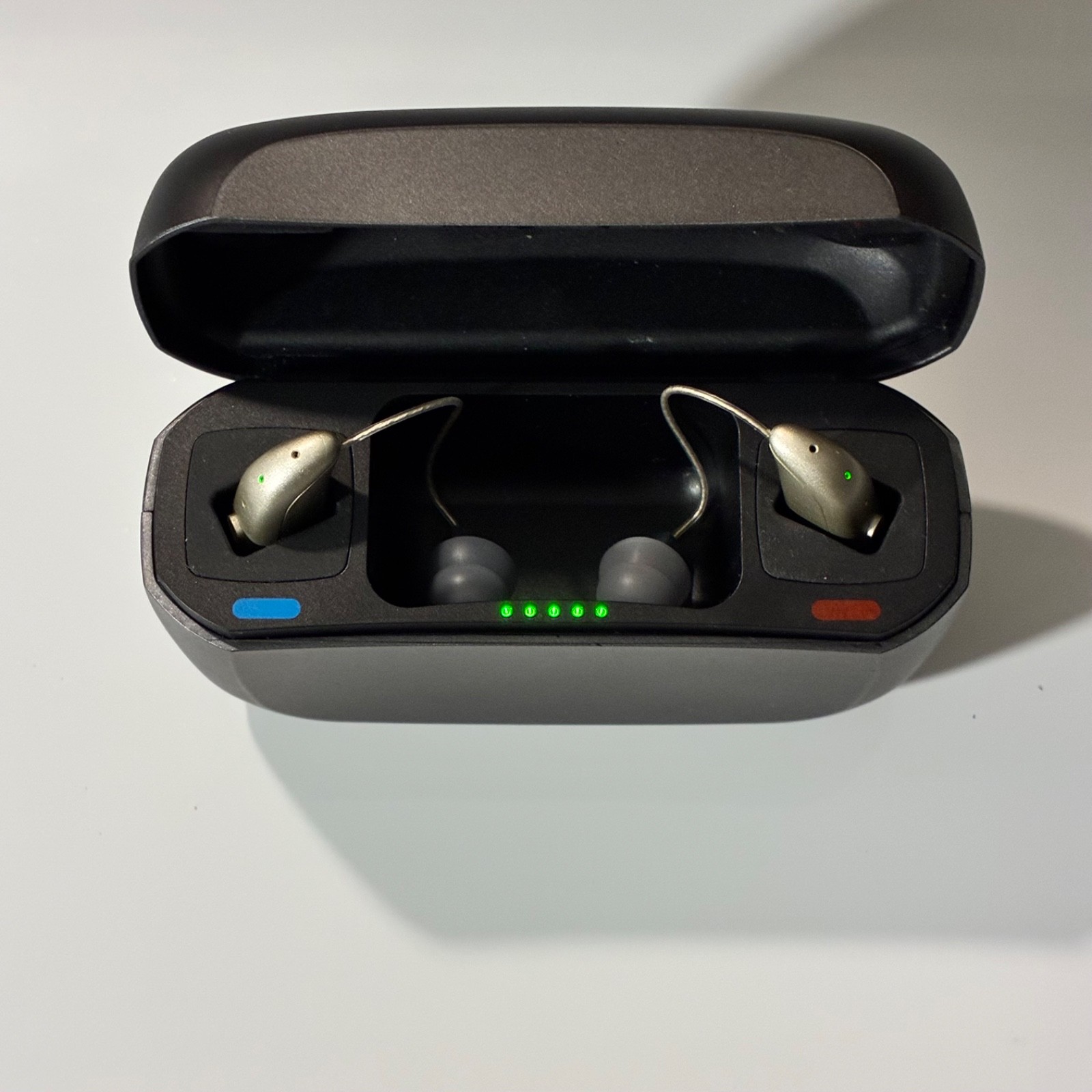 Left and Right Resound GN Hearing Aids and charging station w/cord.