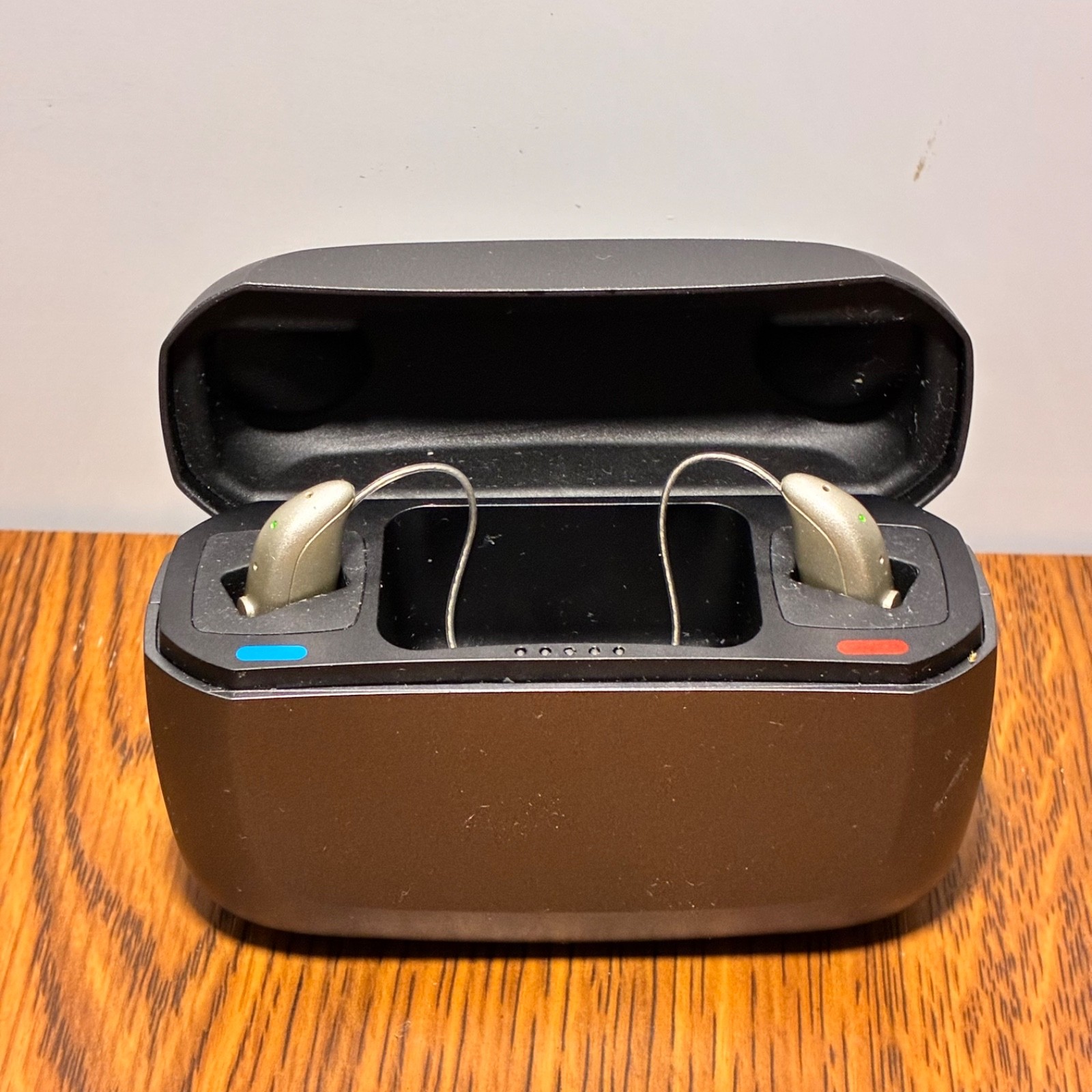 Left and Right Resound GN Hearing Aids and charging station w/cord.